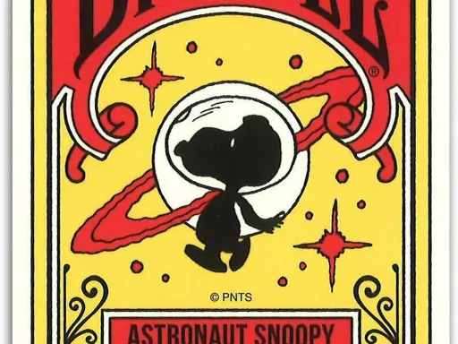 Exclusive to Japan these rare Bicycle Astronaut Snoopy Playing Cards boast a vivid Red and Yellow hue, featuring a Snoopy silhouette with a glass helmet in the foreground and various stellar bodies in the background.