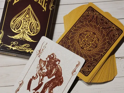 Bicycle Excellence Playing Cards are inspired by the luxurious city of Paris, with it's unique atmosphere and expensive couture. This elegant deck features an intricate guilloché pattern infused with a deep gold metallic ink. The