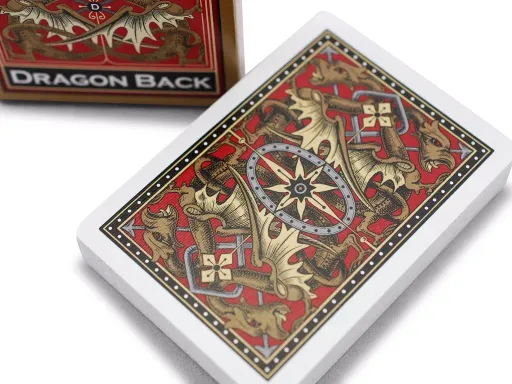 The Bicycle® Gold Dragon Back decks feature a detailed, mirror-image dragon design, as well as a vivid color scheme that includes shades of deep red, gold, and silver. The usual yellow accents of the court