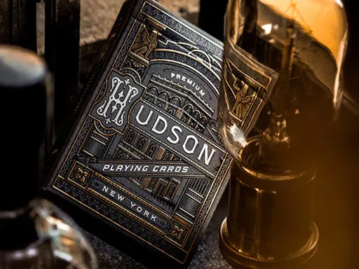 HUDSON BLACK EDITION BY THEORY11 featuring gunmetal grey tuck case and deep black foil laced in gold. The Black Hudson's are classy and a true classic Theory11 deck.The intricate back design and standard courts, make