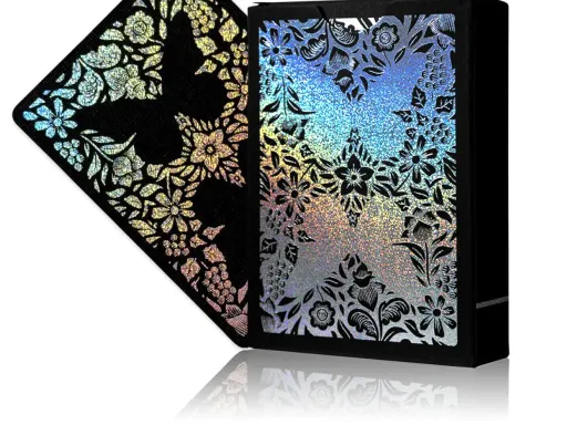 Butterfly Playing Cards Holo Edition! This unique Butterfly deck features a blacked-out design with a black border. The backs and faces use no color. Instead, they are covered with a holographic foil! To complete the