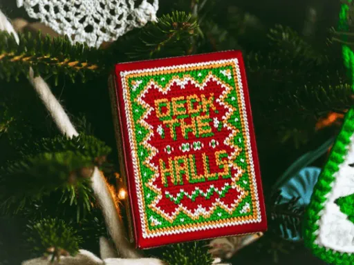 Christmas and its ugly sweaters are fashionable again and Jackson Robinson at Kings Wild Projects created the first Deck The Halls playing cards based on those horrifically ugly sweaters. The most epic part of the