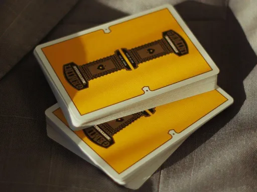 Designed by Toomas Pinston, Gemini Casino Yellow playing cards are inspired by timeless classics such as Jerry's Nugget playing cards and Dunes Casino. The back design features a vibrant yellow color along with a mirrored