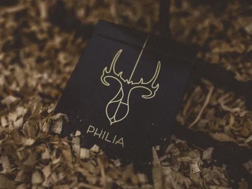 Riffle Shuffle in collaboration with PH present Gold Philia Playing Cards! Philia, translated from its Greek roots means "brotherly love". The simple gold and black back design features two mirrored deer heads, symbolizing a hopeful