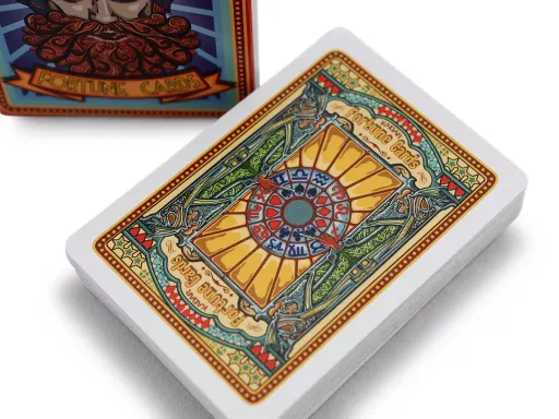 Prepare to see your future for the price of a nickel with this unique deck inspired by vintage boardwalk fortune-telling machines. The tuck box features The Great Kadar, a forbidding, turbaned head ready to tell