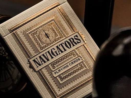 Navigators Playing Cards by Theory 11 are inspired by the tales and adventures of sailors. The intricate back design revolves around a steering wheel, and the custom court cards are sailors out at sea. The