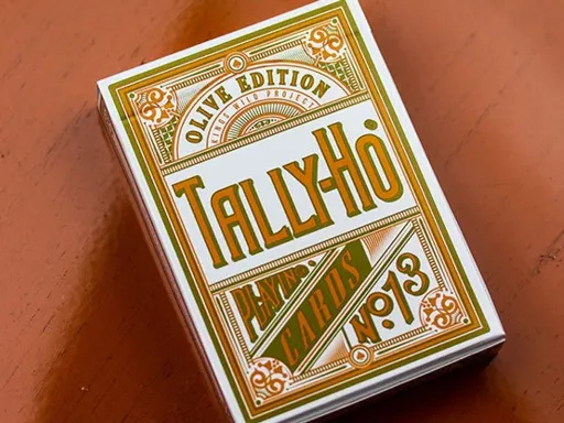 The Olive Tally Ho Playing Cards is the fifth deck in Kings Wild Project's Premium Tally Ho series. Each deck in the series is inspired and named after one of the "girls" in the artist,