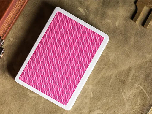 Created by the Bocopo Playing Card Company, the Pink Steel playing cards feature a minimalist design with a simple dot pattern and a thin white border. They are perfect for magicians and cardists. Printed by