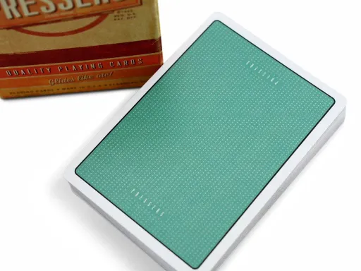 Inspired by Mad Men, AMC's Hit TV Series, this deck features a fully custom, 60s vintage design. The back of the cards features a simple design filled with small, white dots against a tealish green