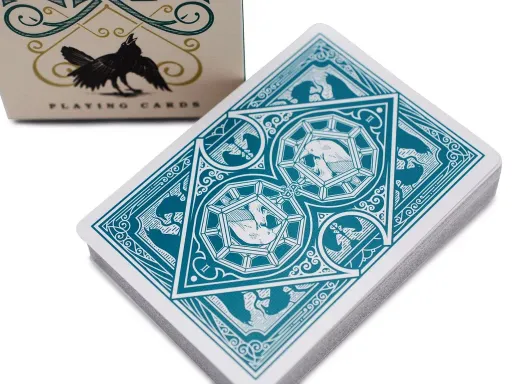 Designed for magician Caroline Ravn, the Ravn playing deck is meticulously crafted with beautiful detail and design. Available in green or red, this deck is adorned with images and silhouettes of ravens, paying tribute to