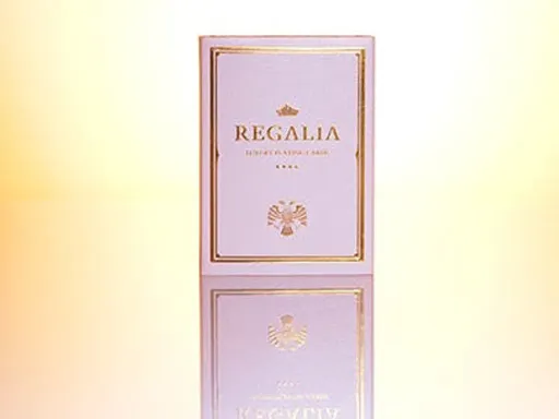 The second edition to the Regalia Playing Cards series draws influence from the creative mind of Shin Lim and is printed in Belgium by Cartamundi.The box is made from two protective pearlized white casings, with