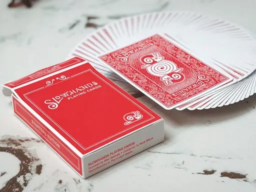 Created by Kier Gomes and designed by Nick Nisco, Slow Hands Playing Cards were made to commemorate the modest beginnings of cardistry and card handlers. The back design, inspired by the classic Bicycle Rider Back,