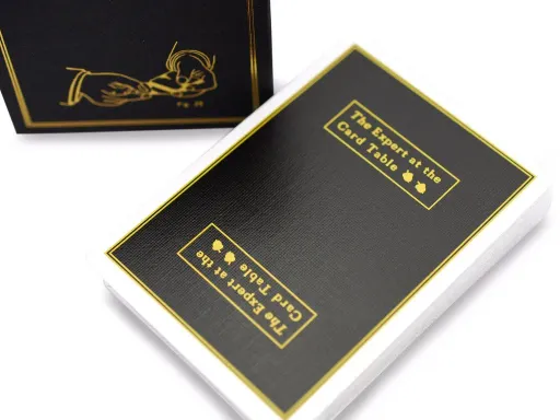 Featured on the back is a deep black replica of Erdnase's green book, and the box is laced with vibrant gold-foil. Distracting other players at the table while you stack the deck in your favor.