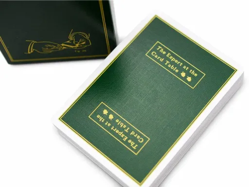 Inspired by Erdnase's book The Expert at the Card Table, the SWE deck is an exact color replica of the book's hardback. Produced by Ellusionist and featuring Daniel Madison's artwork, the deck comes with custom