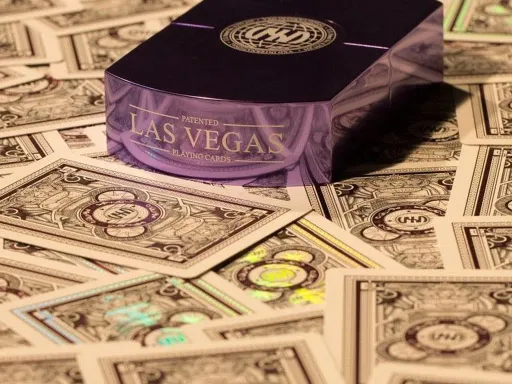 The Vegas Diffractor - Ultraviolet MetalPatented Playing Cards - Featuring Fully Custom Transparent Holographics On Front and Back FacesUltraviolet Foil on Back Faces of Playing CardsPlaying Cards in Black Paper Sleeve, Sealed with Numbered StickerSolid