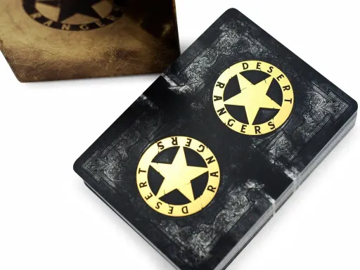 Inspired by the video game, Wasteland 2, Wasteland Desert Ranger Edition Playing Cards features a super sweet gold foil badge design, vintage distressed tuck, and gold foil on the back of every card. These are